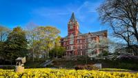 Georgia Tech's tech tower with yellow spring flowers in foreground