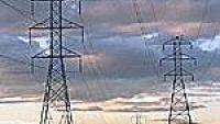 Power lines against a colorful dusk sky.