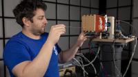 Researcher installing XPAT system in a test chamber